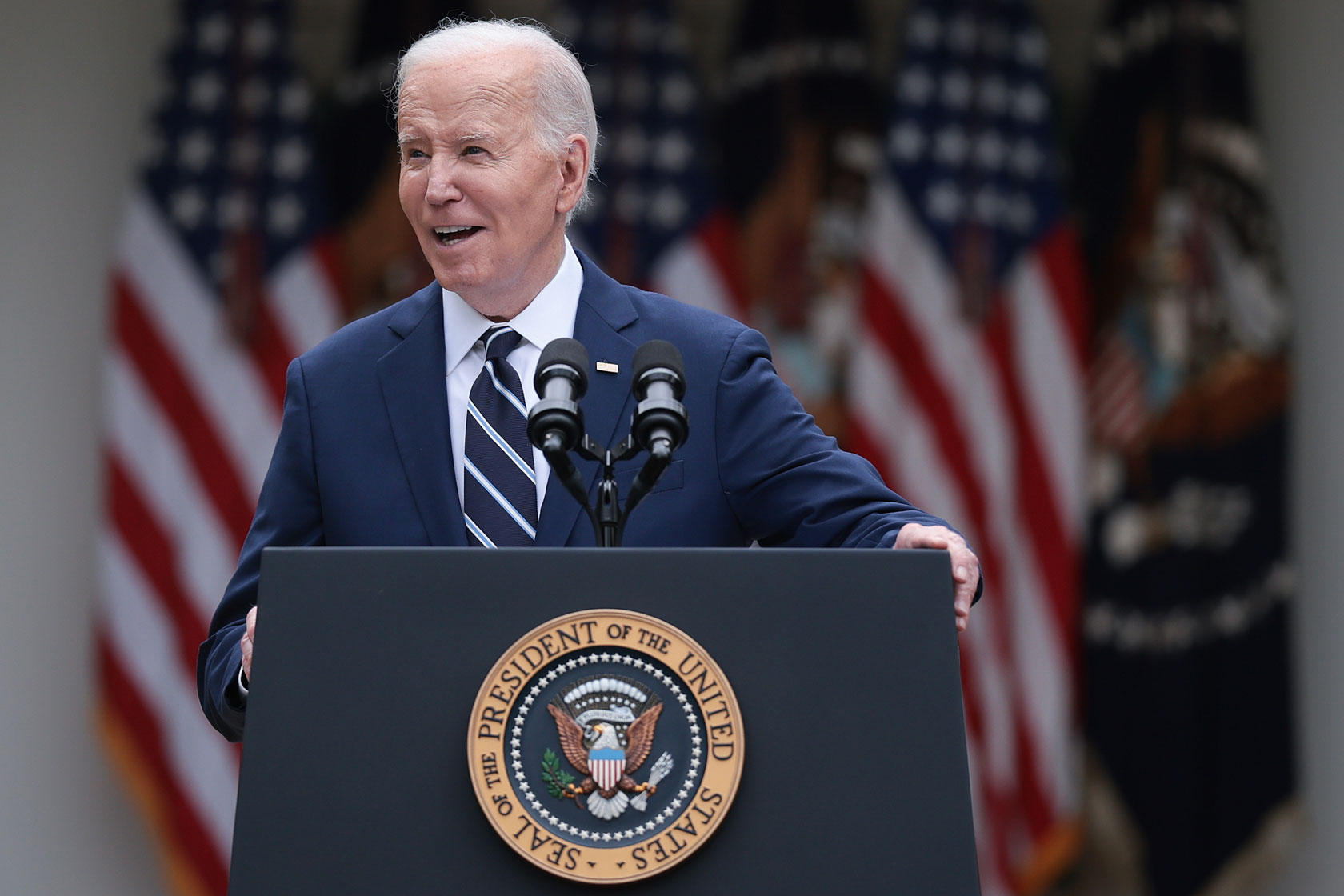 President Joe Biden stands behind a podium.