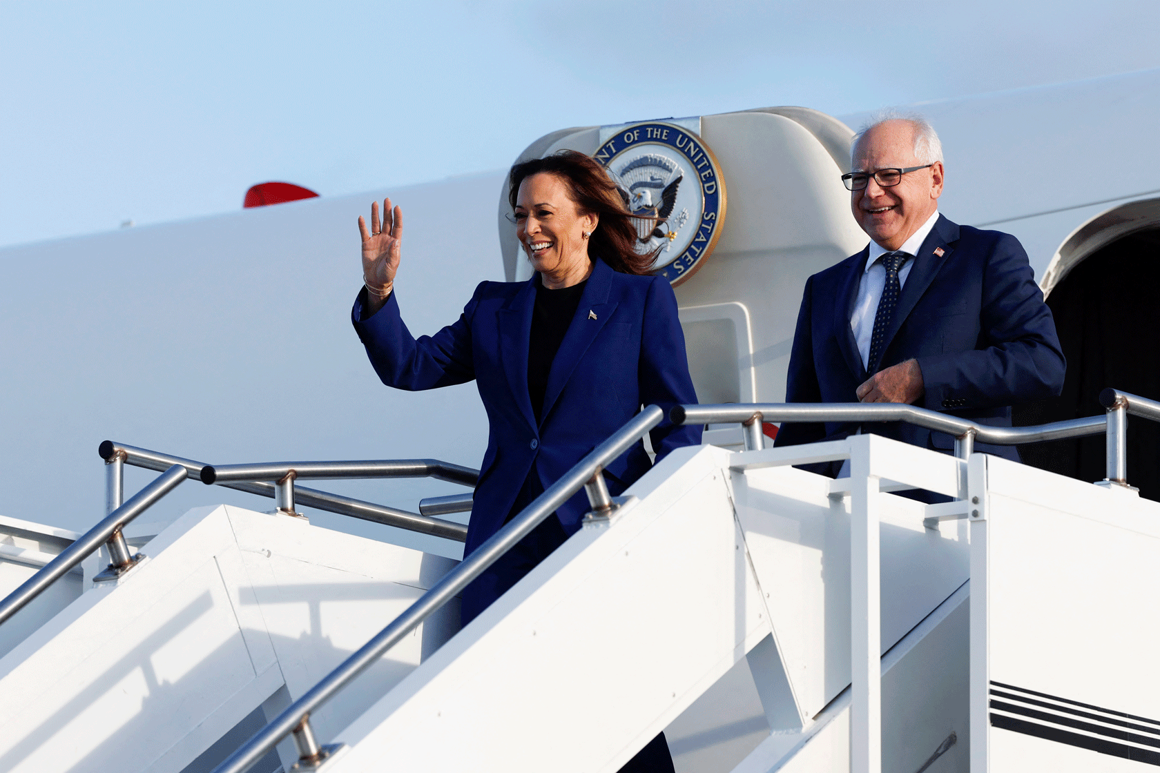 Kamala Harris and Tim Walz are seen getting off an airplane.